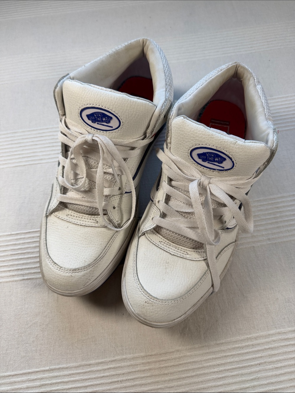 Vans White High-Top Sneakers with Blue Logo Patch